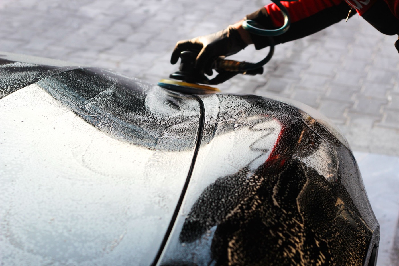 A vehicle panel being polished during detailing